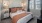 carpeted bedroom with large windows