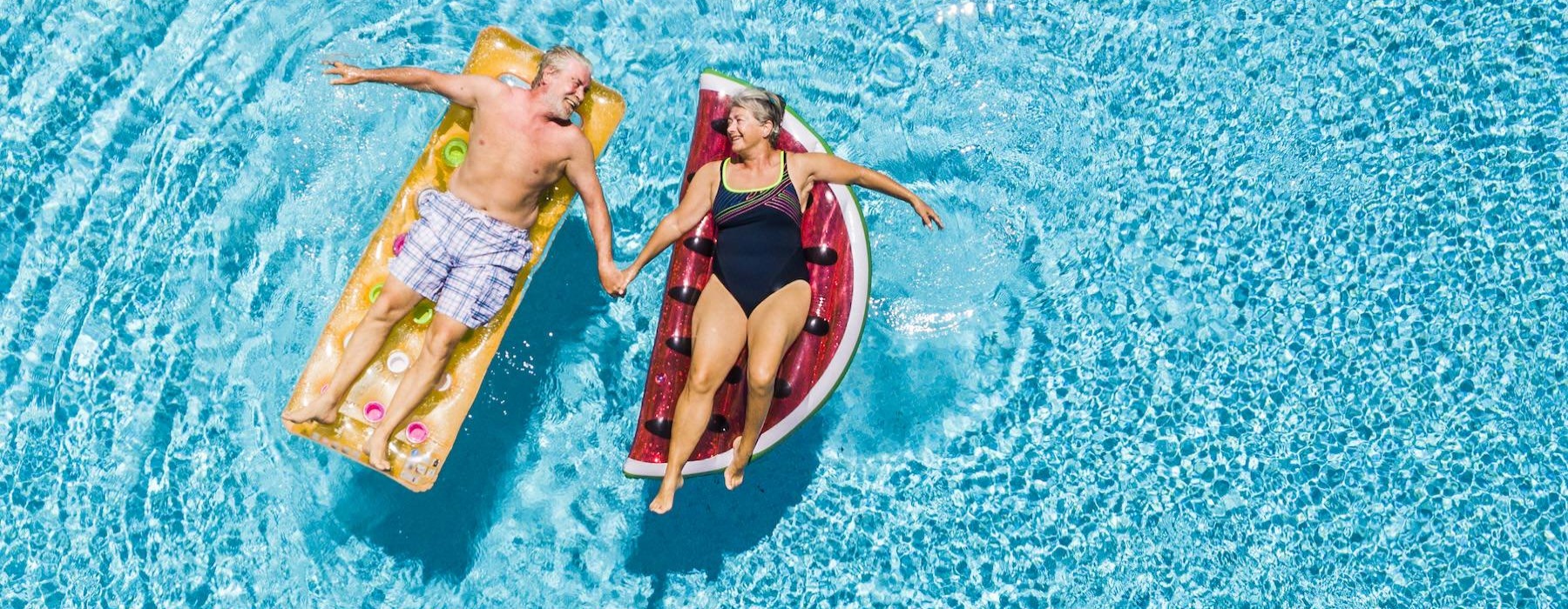 a couple floating in a pool